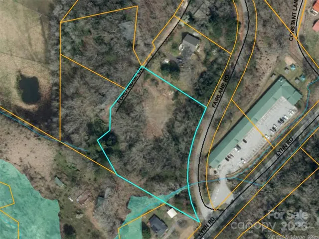 an aerial view of residential house with outdoor space and trees all around