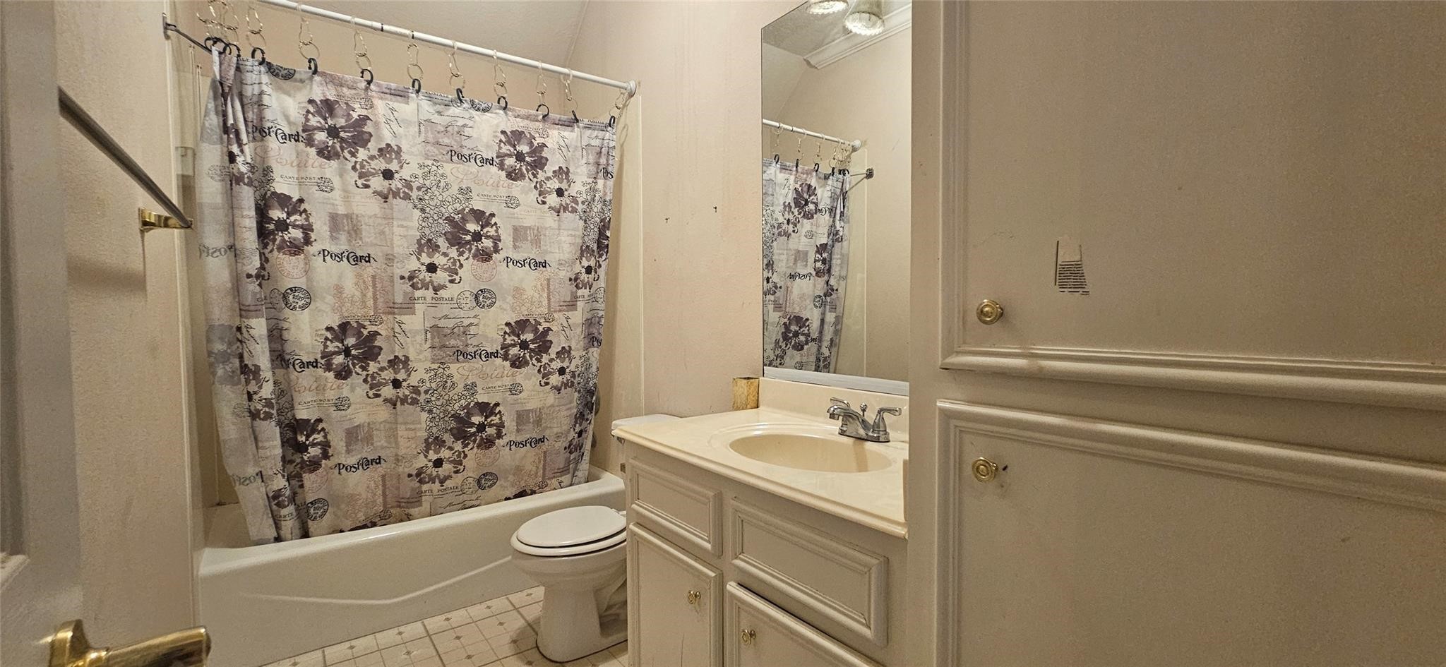1903 North Travis Street Liberty, TX 77575 - Photo 11 of 13 a bathroom with a sink a toilet and shower curtain