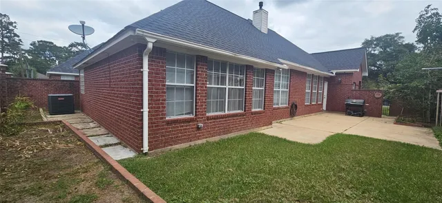 a view of a house with a yard and wooden fence