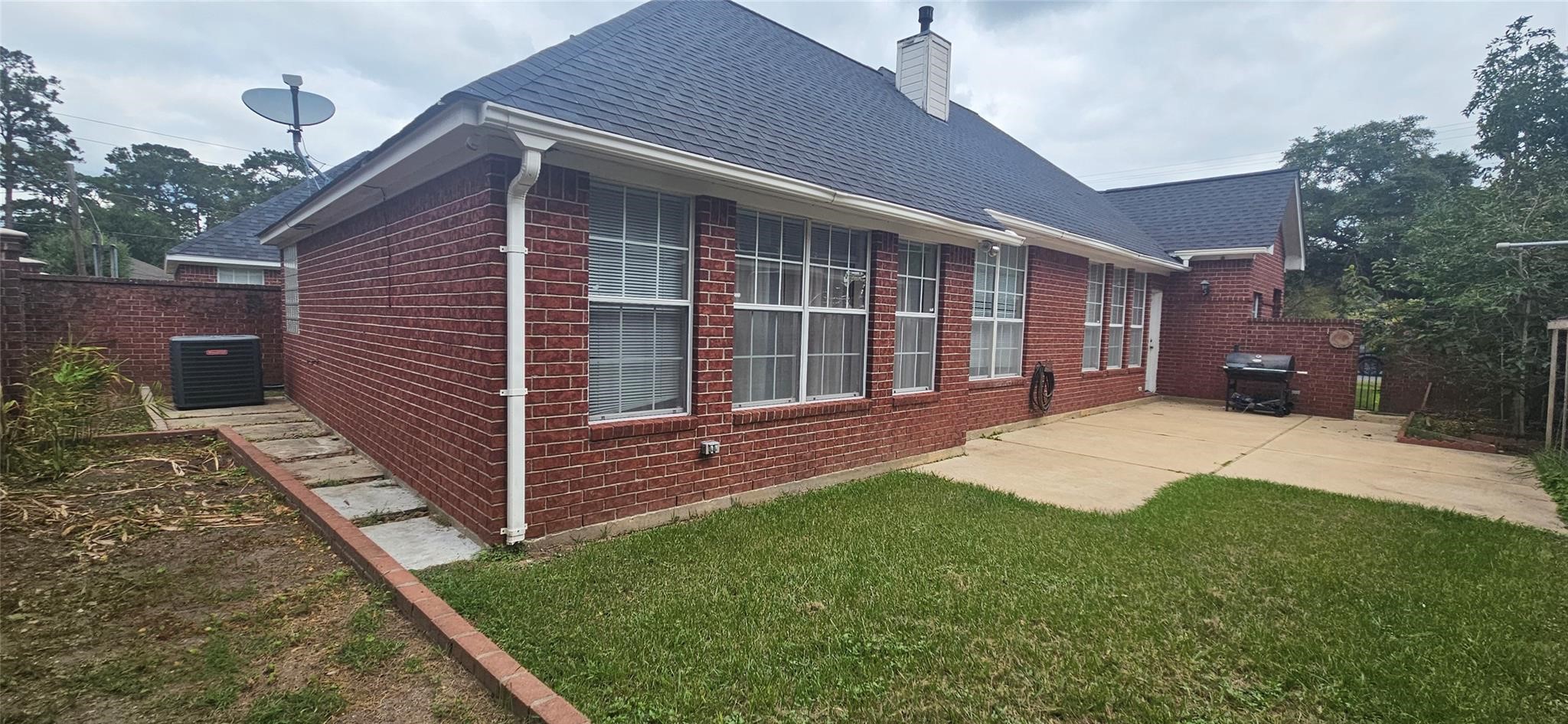 1903 North Travis Street Liberty, TX 77575 - Photo 13 of 13 a view of a house with a yard and wooden fence