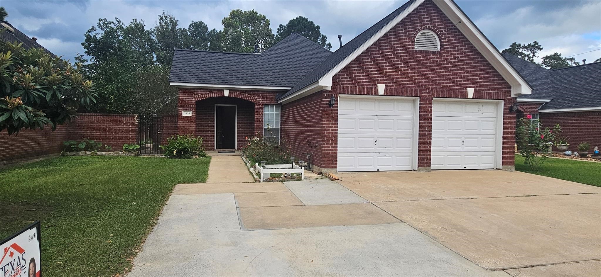 1903 North Travis Street Liberty, TX 77575 - Photo 3 of 13 a front view of a house with a yard and garage