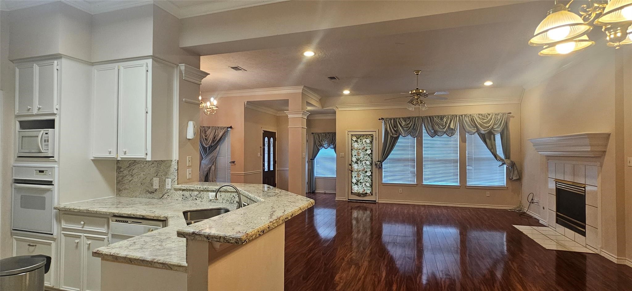1903 North Travis Street Liberty, TX 77575 - Photo 8 of 13 a view of living room kitchen with furniture and fireplace