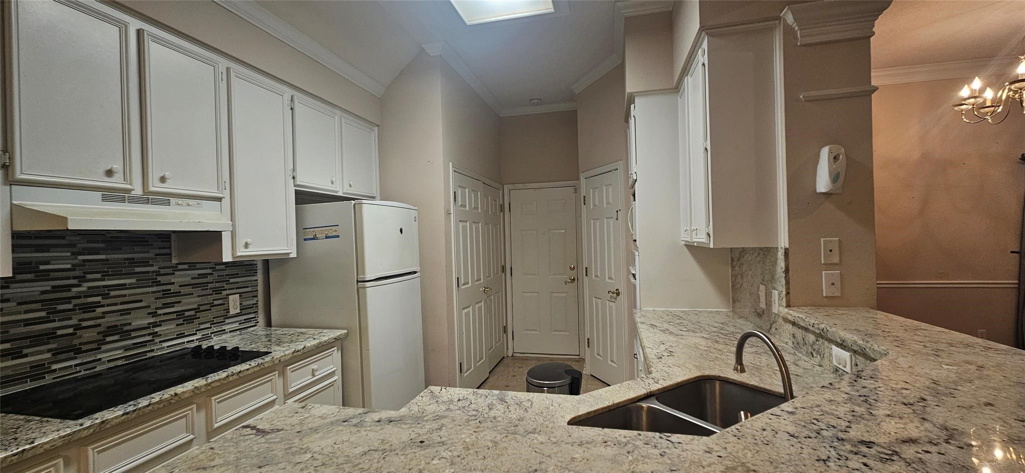 1903 North Travis Street Liberty, TX 77575 - Photo 9 of 13 a kitchen with stainless steel appliances granite countertop a sink stove and refrigerator