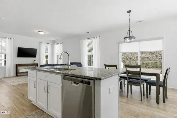 a kitchen with granite countertop a sink counter top space and stainless steel appliances