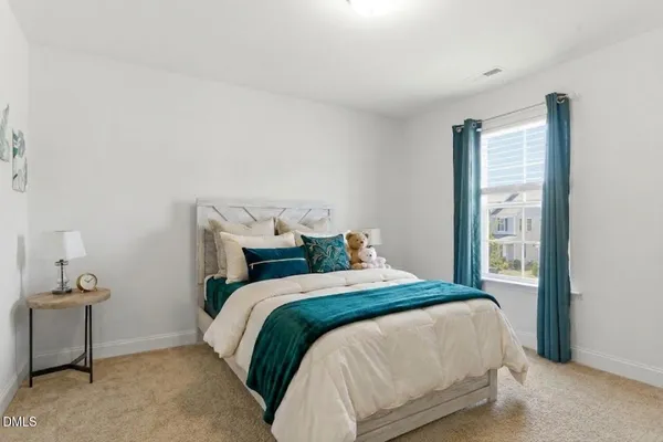 a bedroom with a bed and cabinet