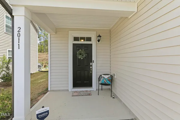 a view of a porch with a table and chairs