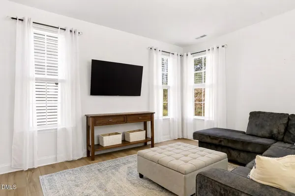 a living room with furniture a flat screen tv and a fireplace