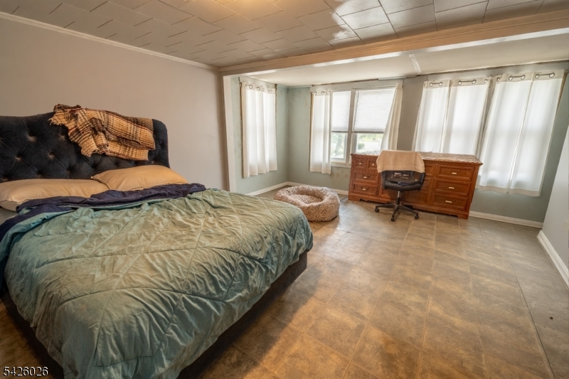 813 George Street Plainfield, NJ 07062 - Photo 3 of 10 a bedroom with a bed and wooden floor