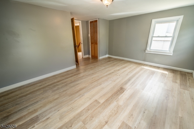813 George Street Plainfield, NJ 07062 - Photo 6 of 10 an empty room with wooden floor and windows