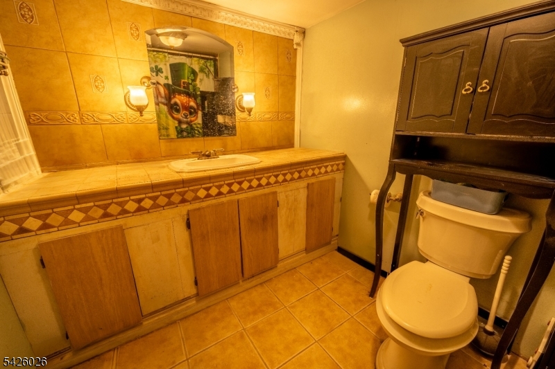 813 George Street Plainfield, NJ 07062 - Photo 7 of 10 a bathroom with a toilet mirror and vanity