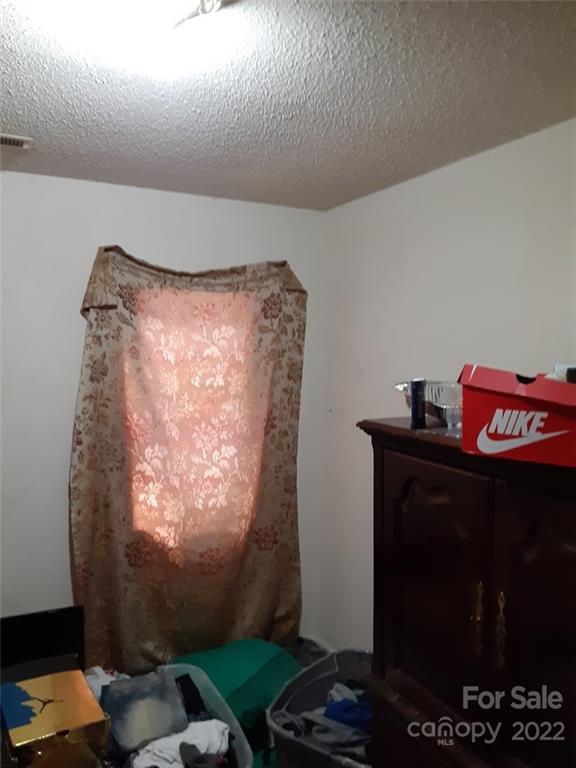 317 South Ransom Street Gastonia, NC 28052 - Photo 13 of 23 a room with furniture and a lamp