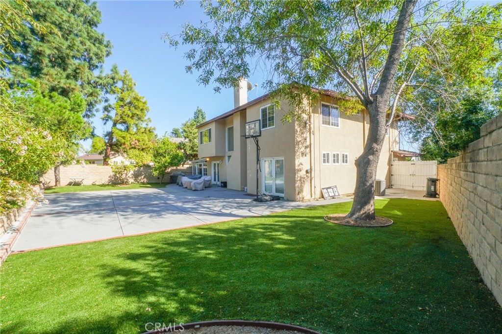19259 Kenya Street Porter Ranch, CA 91326 - Photo 17 of 31 a backyard of a house with plants and large tree