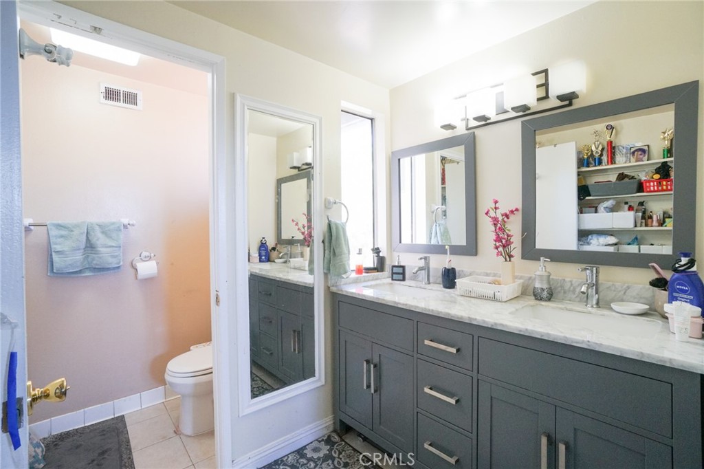 19259 Kenya Street Porter Ranch, CA 91326 - Photo 20 of 31 a bathroom with a double vanity sink toilet and shower