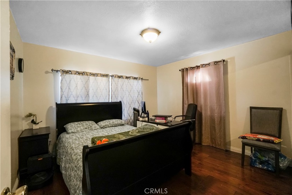 19259 Kenya Street Porter Ranch, CA 91326 - Photo 22 of 31 a bed sitting in a bedroom next to a window and a flat screen tv