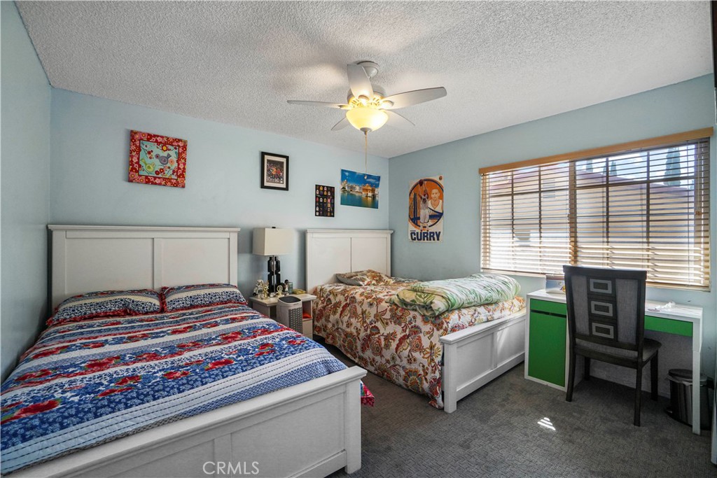 19259 Kenya Street Porter Ranch, CA 91326 - Photo 30 of 31 a bedroom with a bed and a chandelier