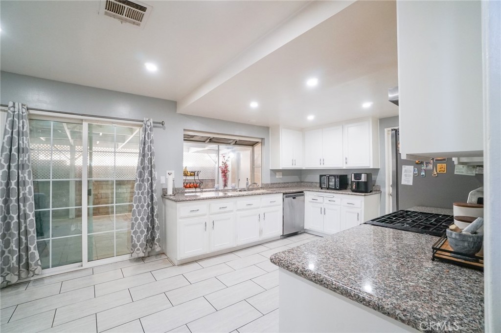 19259 Kenya Street Porter Ranch, CA 91326 - Photo 10 of 31 a kitchen with sink cabinets and stove top oven