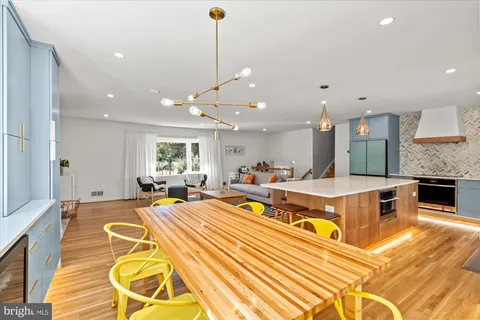 a large room with kitchen island a chandelier and living room view
