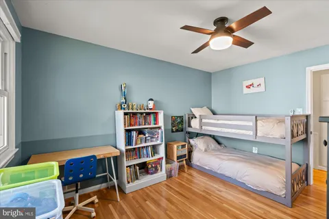 a living room with furniture and a book shelf