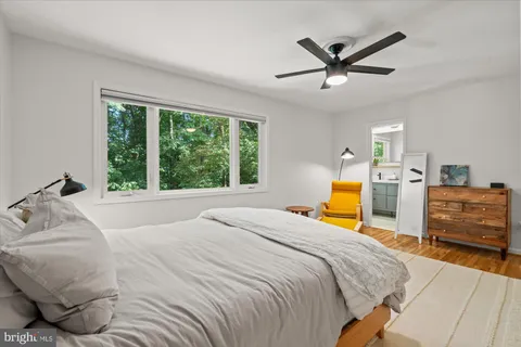 a bedroom with a bed and a large window
