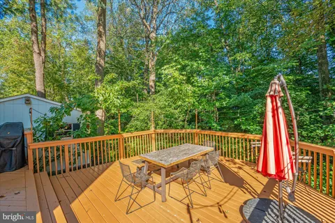 a view of a deck with two chair and wooden floor