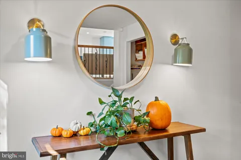 a front view of a house with wooden floor and potted plants