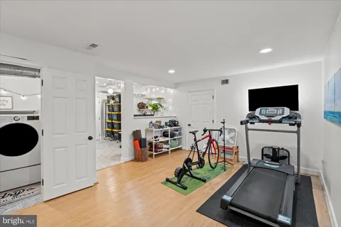 a room with gym equipment and a flat screen tv