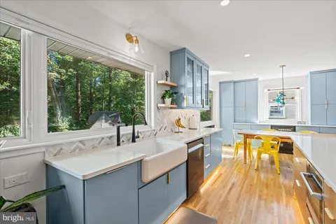 a kitchen with a sink and large windows