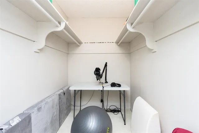 a view of walk in closet with clothes