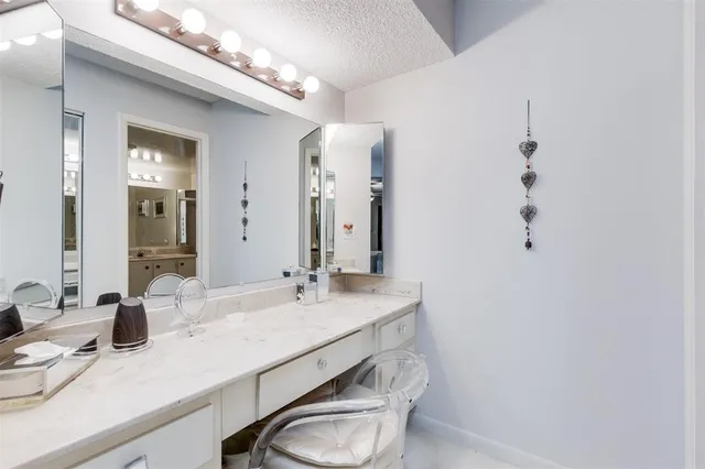 a bathroom with a sink vanity mirror and toilet