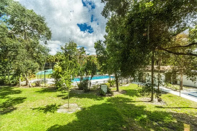 a living room with furniture a window and gym equipment