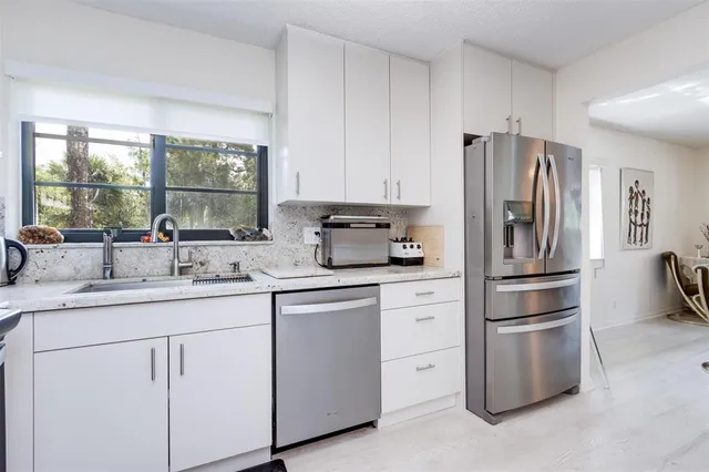 a spacious bathroom with a granite countertop sink and a mirror