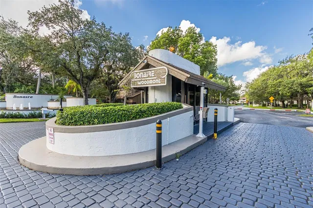 a view of a building with cars parked on the road