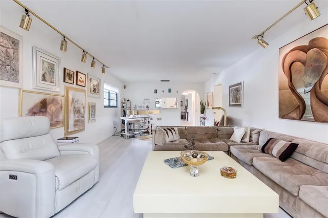 a living room with furniture and a large window with outer view