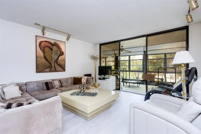 a spacious bedroom with a bed and a large window