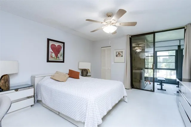 a large bedroom with a bed and a chandelier