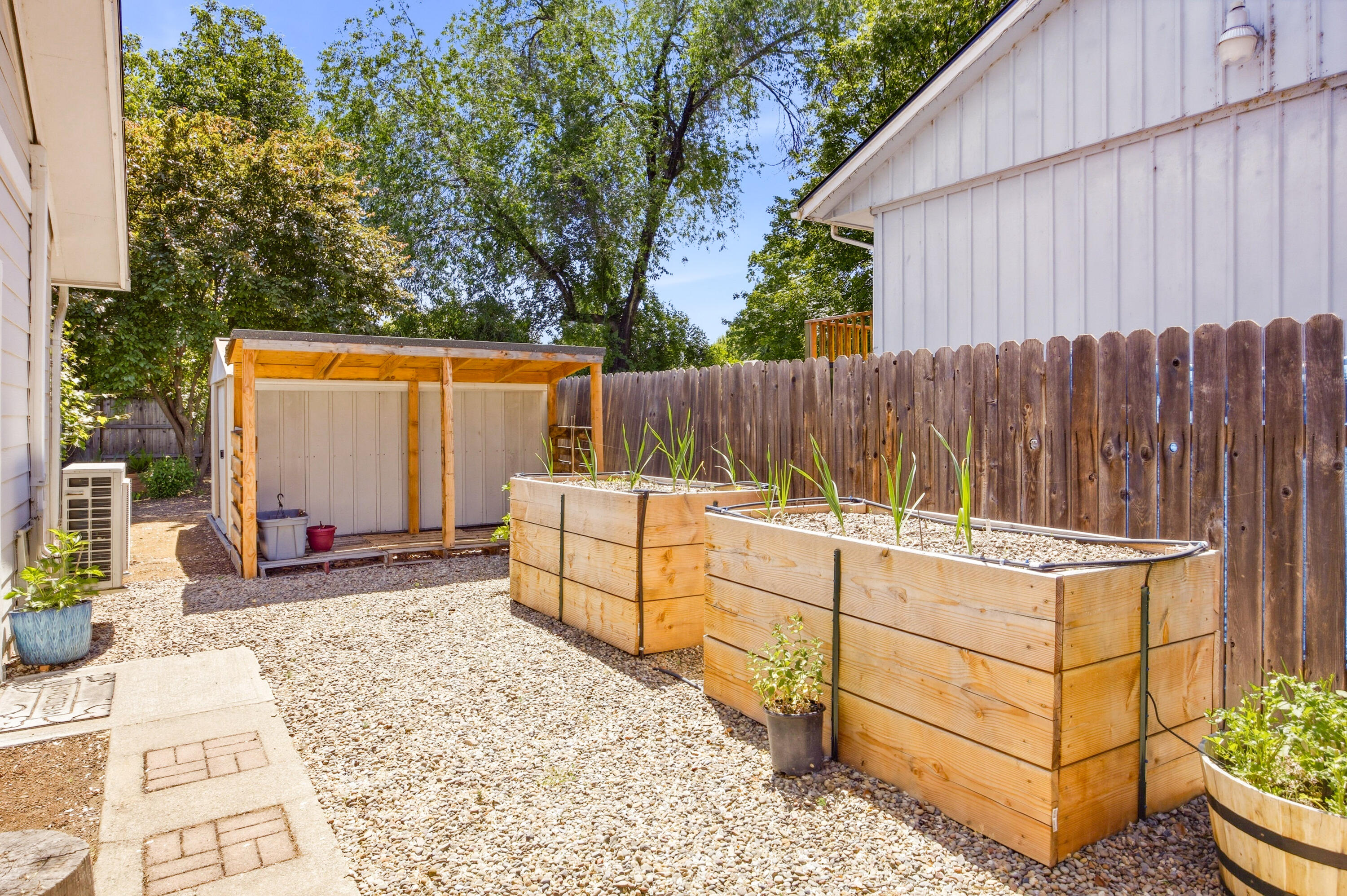 659 Herman Avenue Medford, OR 97501 - Photo 7 of 42 a view of a backyard with a tub and wooden fence