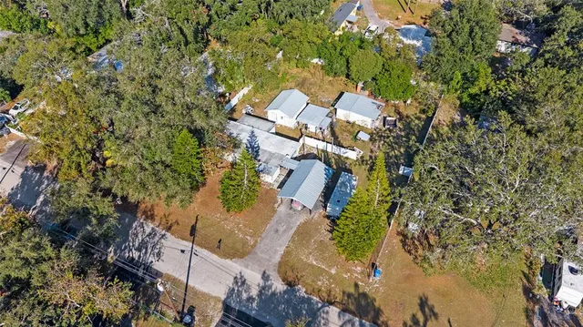 an aerial view of a house with a yard and garden
