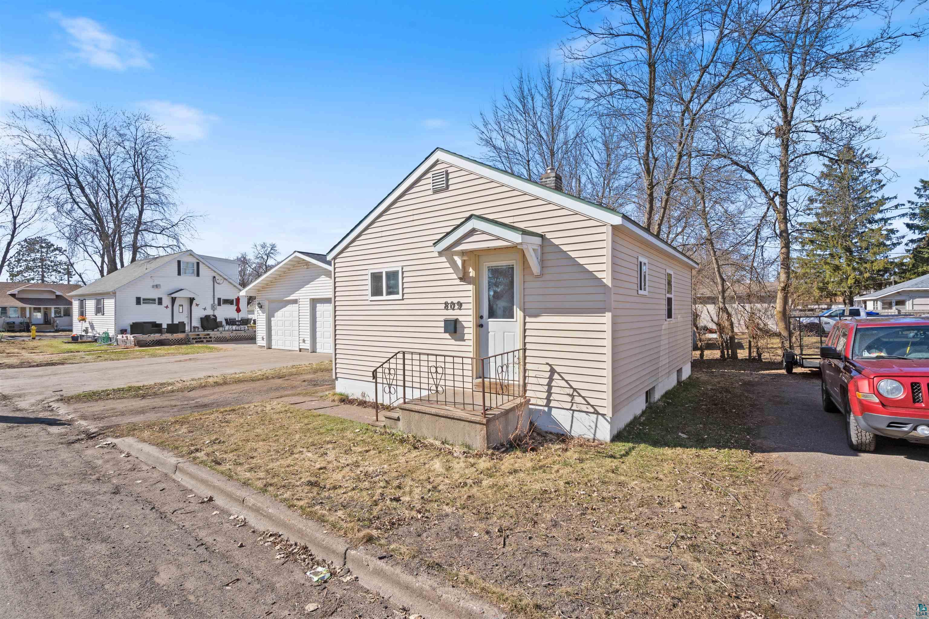 View of front of property featuring a residential view and an outbuilding