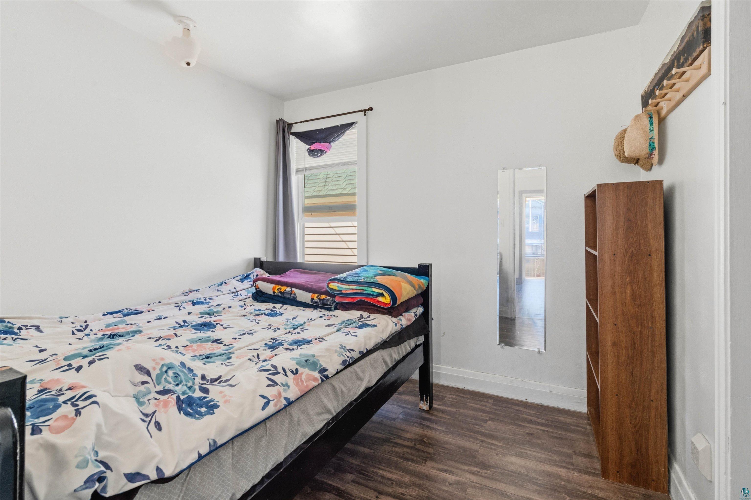 809 Prospect Avenue Cloquet, MN 55720 - Photo 13 of 20 Bedroom with dark wood-style floors and baseboards