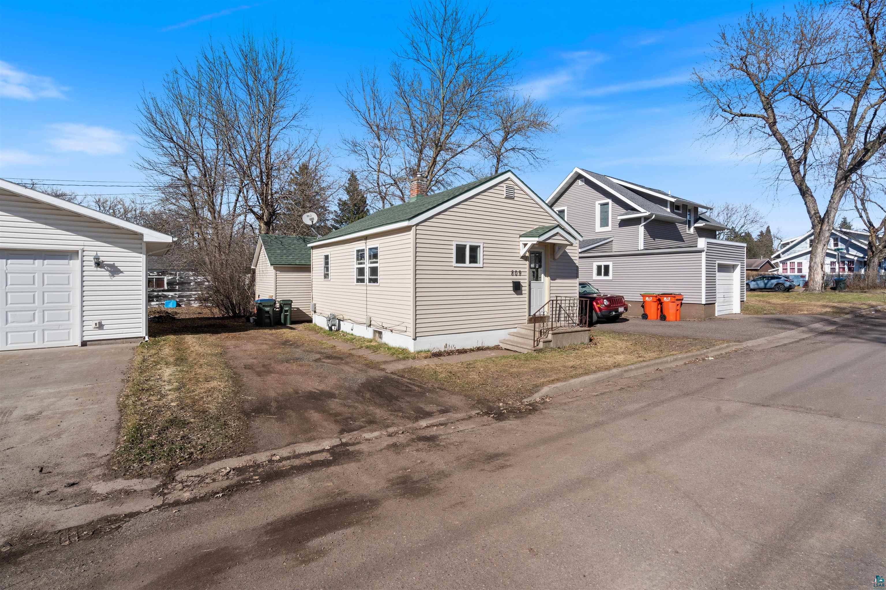 809 Prospect Avenue Cloquet, MN 55720 - Photo 20 of 20 View of front of house featuring a garage and an outdoor structure