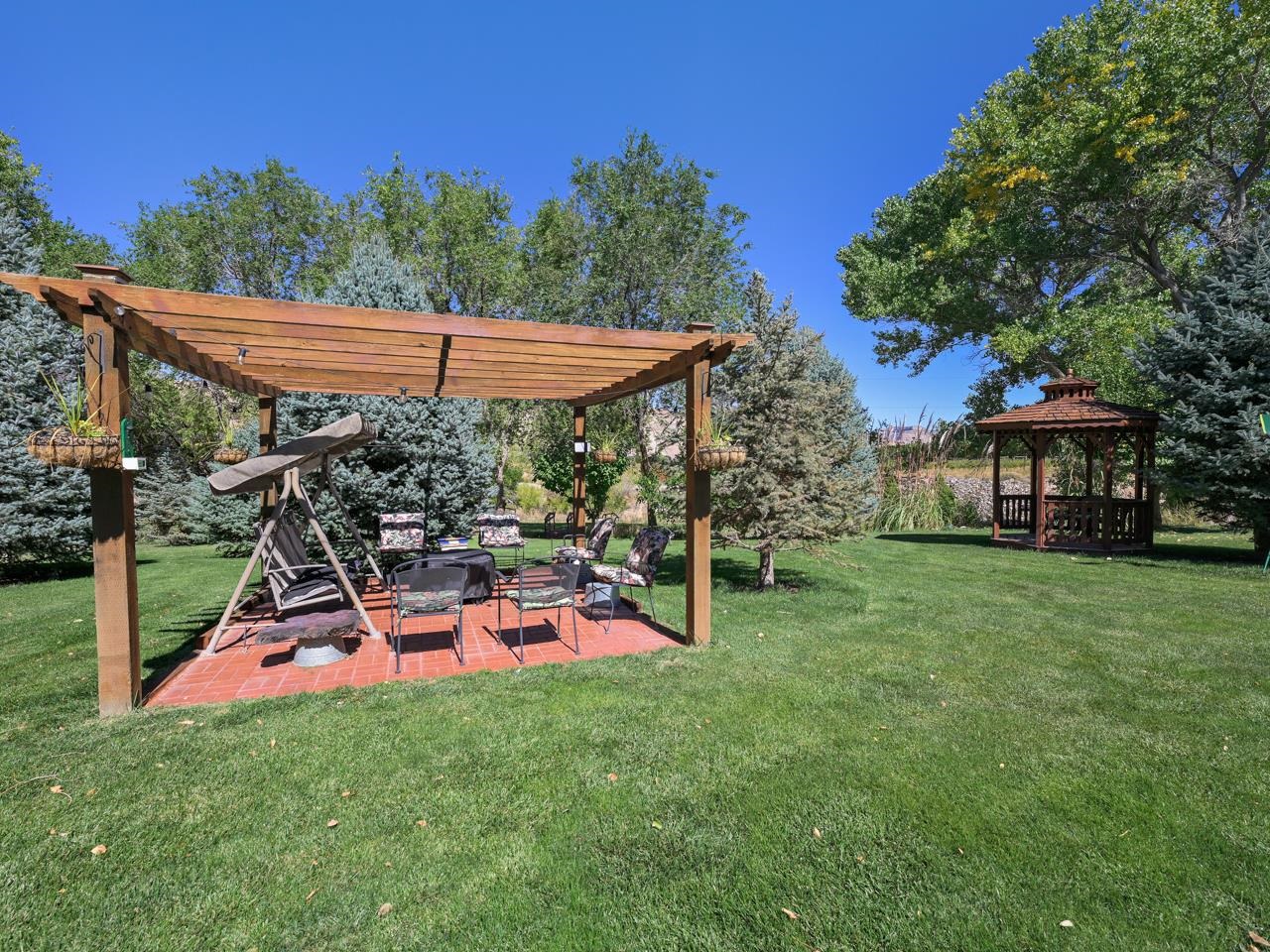 3694 F Road Palisade, CO 81526 - Photo 4 of 42 a view of a patio with table and chairs under an umbrella