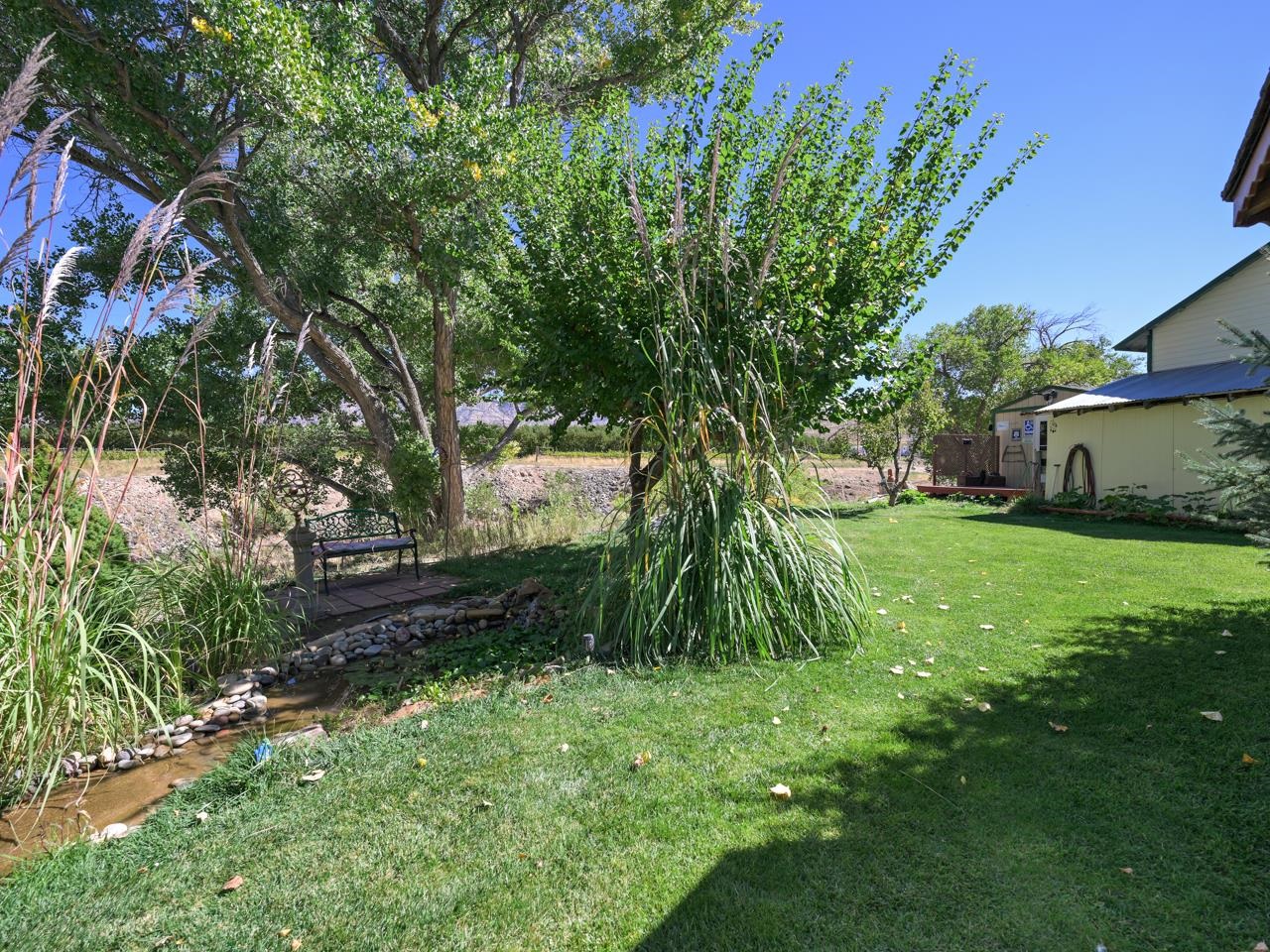 3694 F Road Palisade, CO 81526 - Photo 9 of 42 a backyard of a house with lots of green space