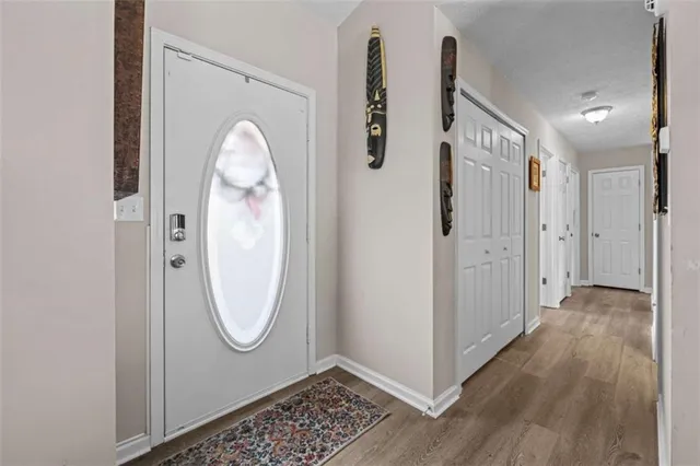 a view of a livingroom with wooden floor and white walls