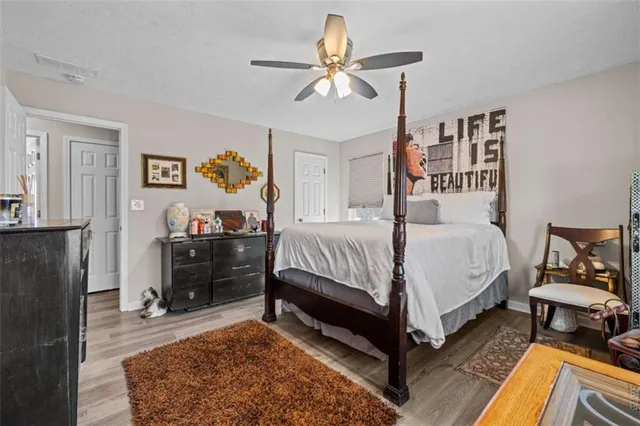 a bedroom with a bed and a dresser in it