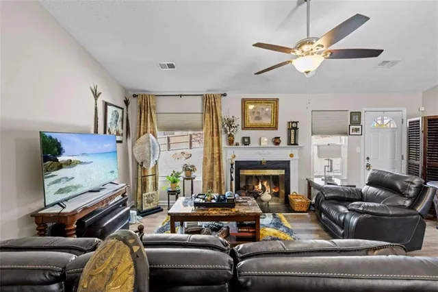 a living room with furniture fireplace and a flat screen tv