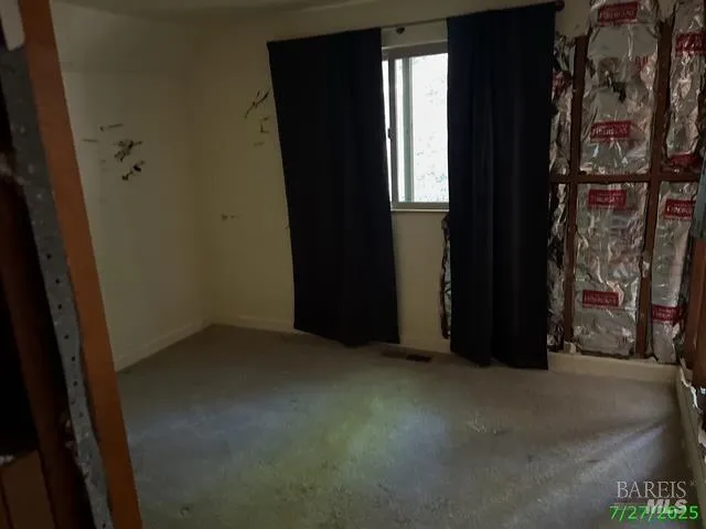 a view of a closet area with wooden floor