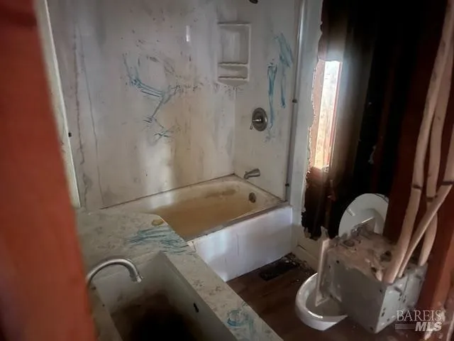 a bath tub sitting next to a bathroom sink