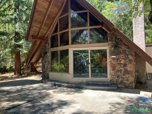 a view of a house with a window and a tree