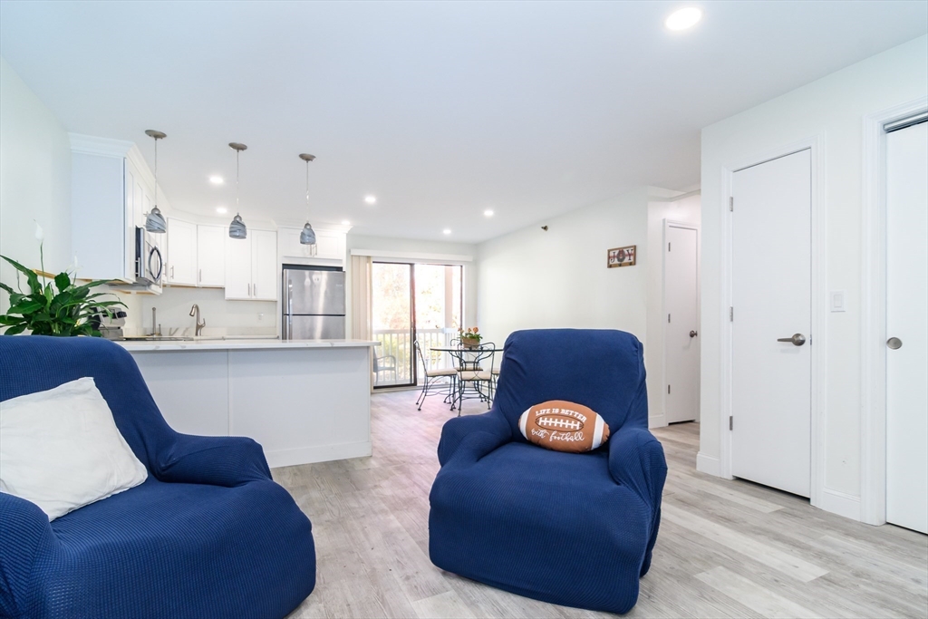 71 Edgeworth Street, Unit 21 Worcester, MA 01605 - Photo 4 of 13 a living room with furniture and wooden floor