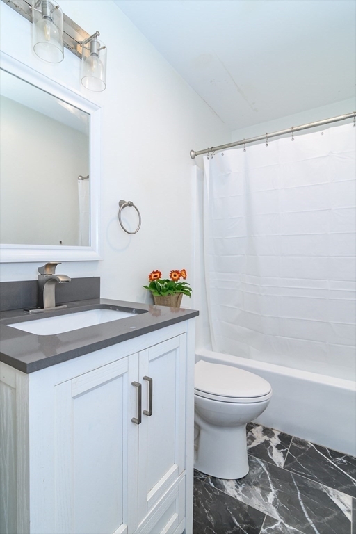 71 Edgeworth Street, Unit 21 Worcester, MA 01605 - Photo 10 of 13 a bathroom with a sink toilet and shower